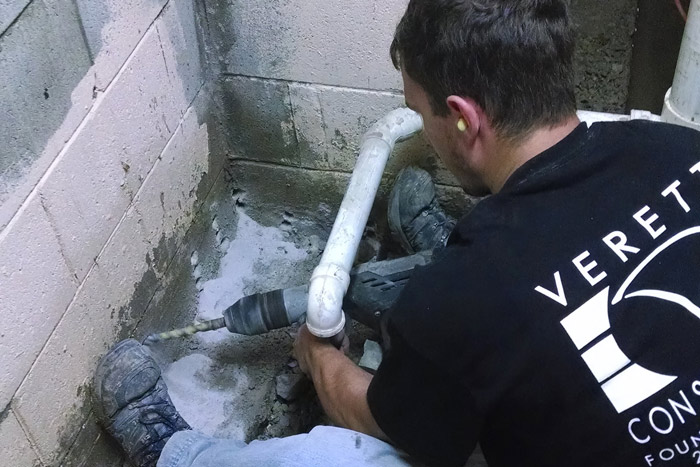 a verette construction employee working on repairing building foundation